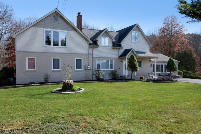 rear view of property with a yard