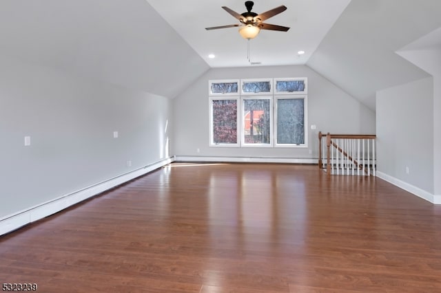 bonus room with baseboard heating, dark hardwood / wood-style flooring, lofted ceiling, and ceiling fan