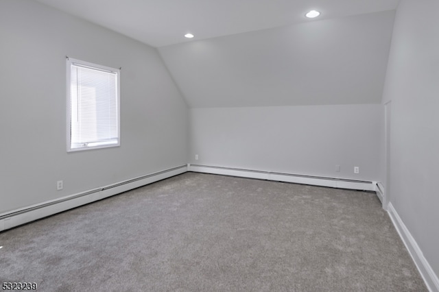 bonus room with lofted ceiling, light colored carpet, and a baseboard heating unit