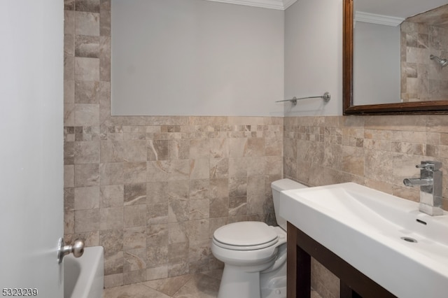 bathroom featuring vanity, crown molding, tile patterned floors, toilet, and tile walls