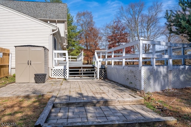 view of patio / terrace featuring a storage shed and a deck