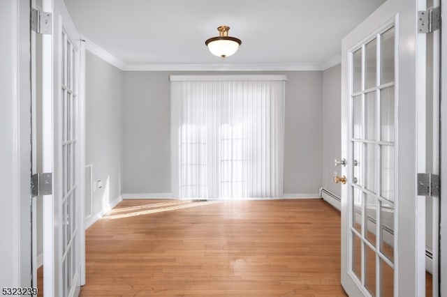 unfurnished room featuring light wood-type flooring, french doors, and ornamental molding