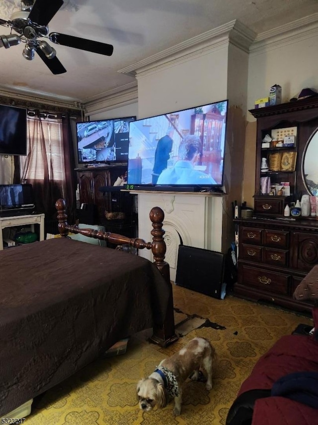 carpeted bedroom featuring ceiling fan and crown molding