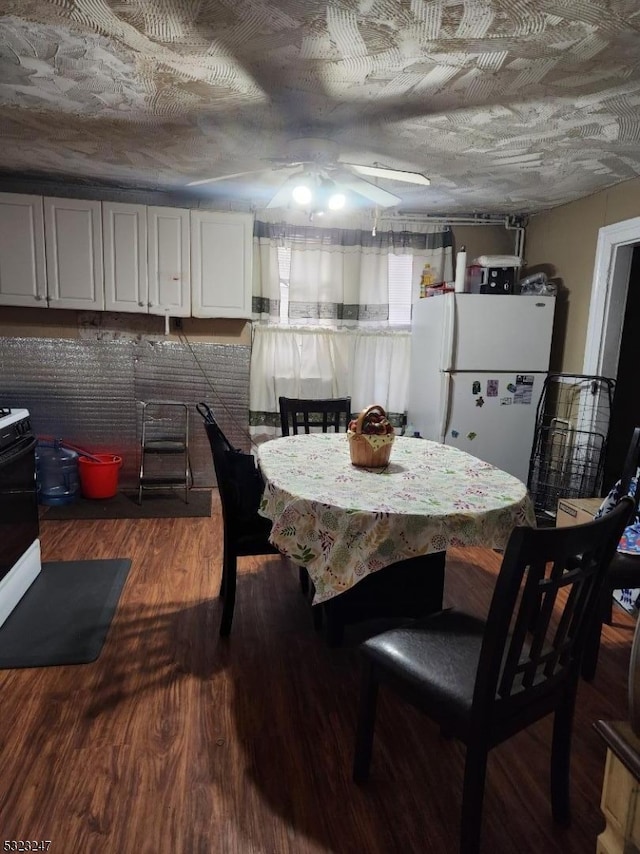 dining room with dark hardwood / wood-style flooring and a textured ceiling