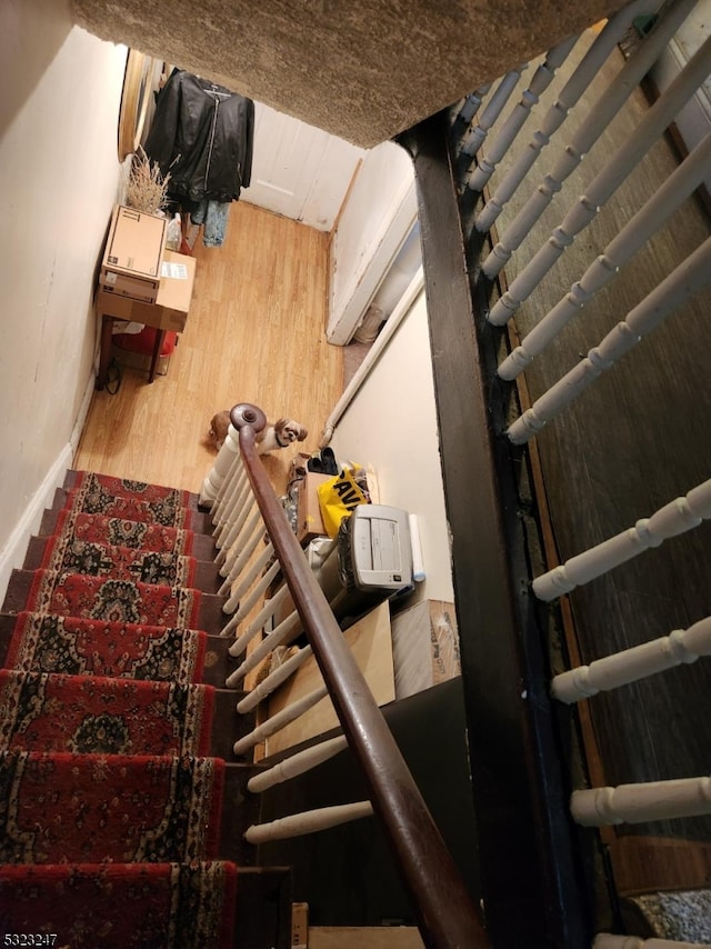 stairs with hardwood / wood-style flooring