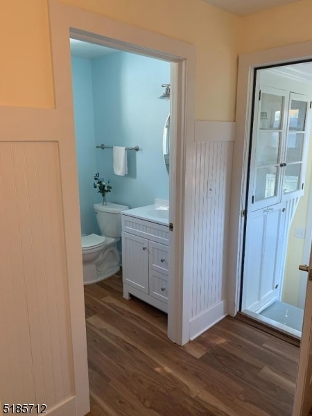 bathroom featuring vanity, hardwood / wood-style flooring, and toilet