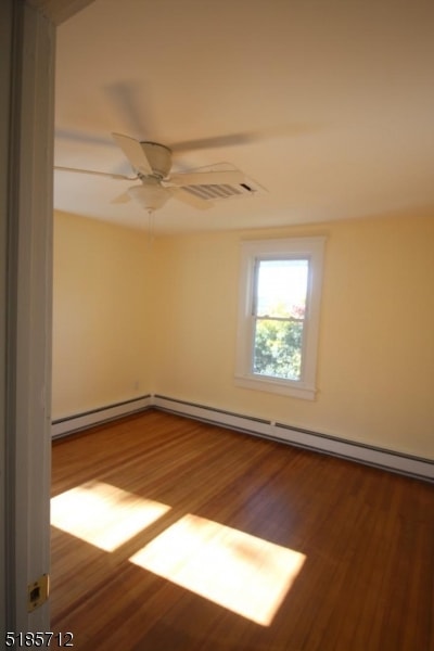 empty room featuring hardwood / wood-style flooring and ceiling fan