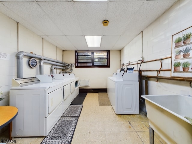 clothes washing area featuring washing machine and dryer and sink