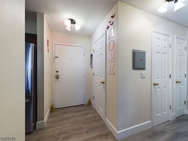 interior space with electric panel and wood-type flooring