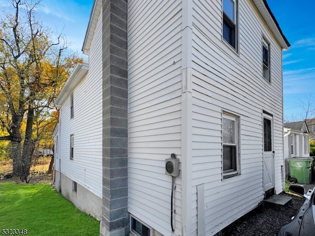 view of property exterior with a lawn