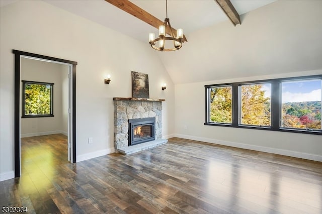 unfurnished living room featuring a stone fireplace, a notable chandelier, beam ceiling, high vaulted ceiling, and hardwood / wood-style flooring