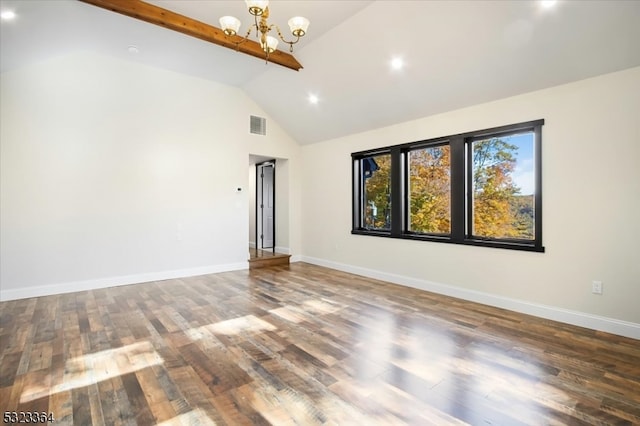 empty room featuring beamed ceiling, hardwood / wood-style flooring, a chandelier, and high vaulted ceiling