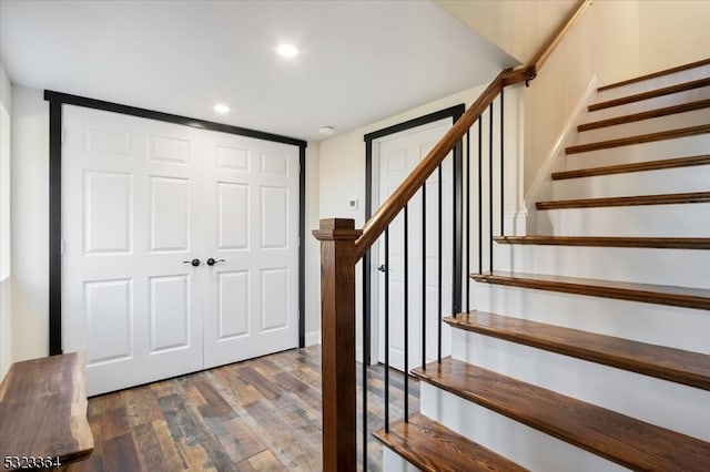 stairway with hardwood / wood-style floors