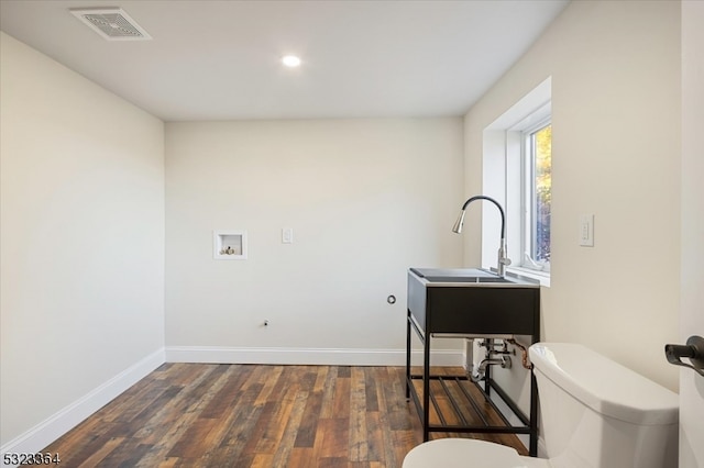 bathroom featuring wood-type flooring and toilet