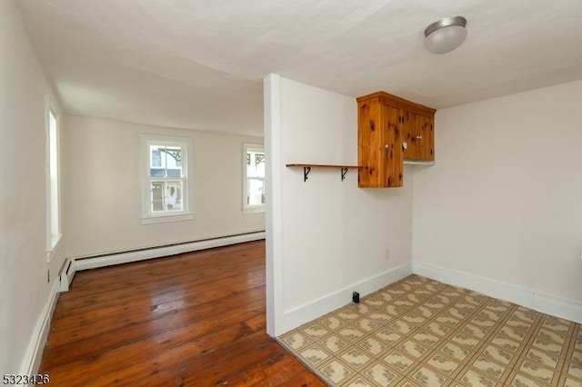 interior space featuring hardwood / wood-style flooring and a baseboard heating unit