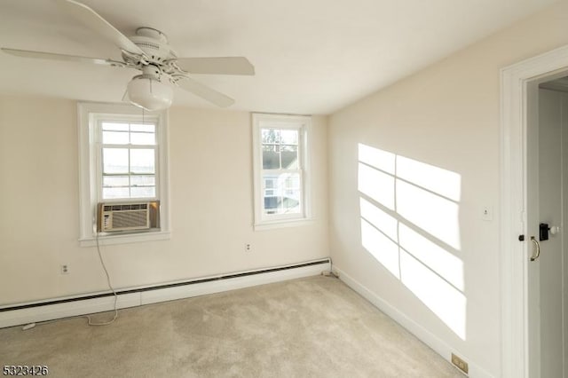 carpeted empty room with ceiling fan, plenty of natural light, cooling unit, and a baseboard heating unit