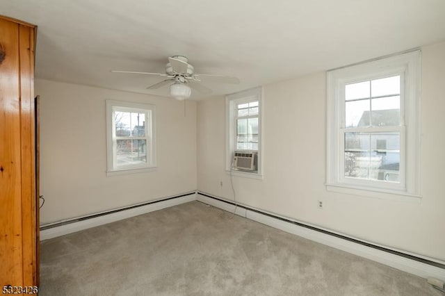 spare room featuring plenty of natural light, ceiling fan, light colored carpet, and cooling unit