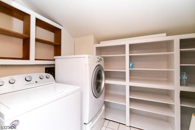 laundry room featuring independent washer and dryer and light tile patterned floors