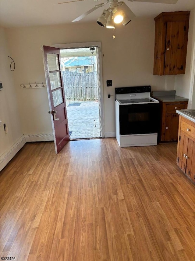 kitchen featuring light wood-type flooring, white electric stove, and ceiling fan