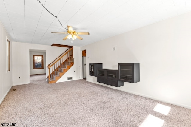 carpeted living room featuring ceiling fan