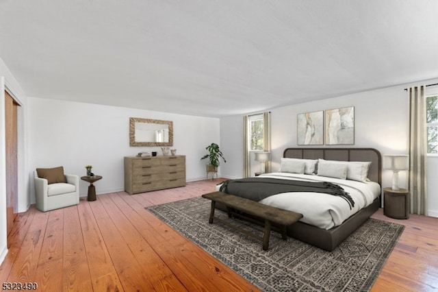 bedroom featuring multiple windows and hardwood / wood-style flooring