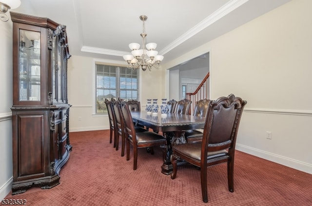 carpeted dining room featuring crown molding, a tray ceiling, and a chandelier