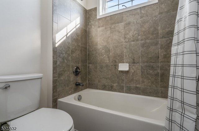 bathroom featuring shower / bath combination with curtain and toilet