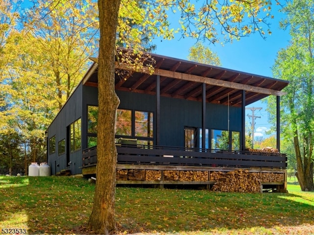 rear view of house featuring a yard