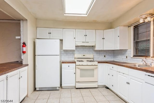 kitchen with decorative backsplash, white cabinetry, white appliances, and sink