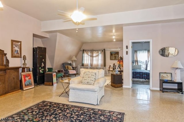 living room with ceiling fan and lofted ceiling