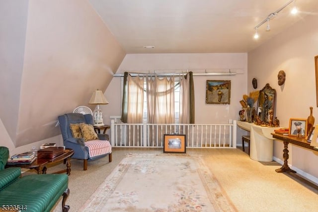 sitting room featuring carpet floors and lofted ceiling