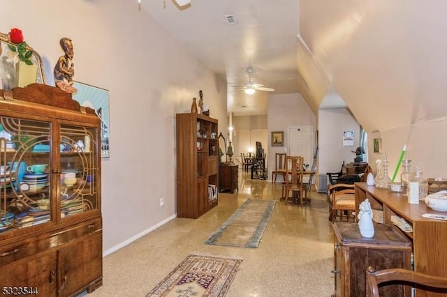 interior space featuring light colored carpet, vaulted ceiling, and ceiling fan