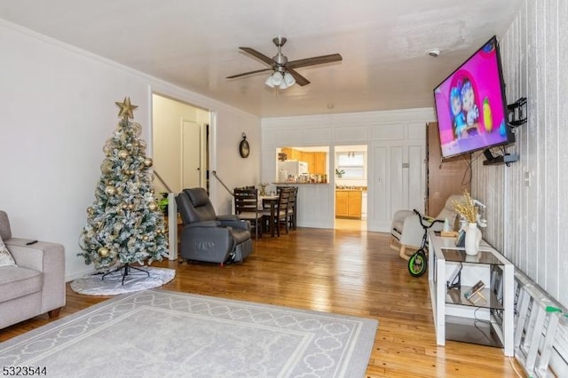 living room featuring ceiling fan and wood-type flooring