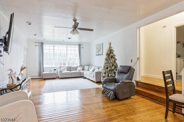 living room with light hardwood / wood-style flooring and ceiling fan