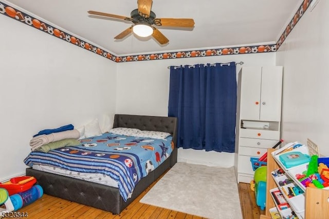 bedroom featuring ceiling fan and hardwood / wood-style floors