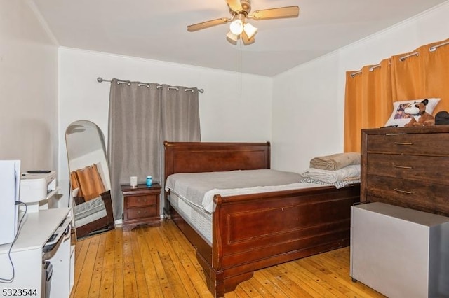 bedroom featuring ceiling fan, crown molding, and light wood-type flooring