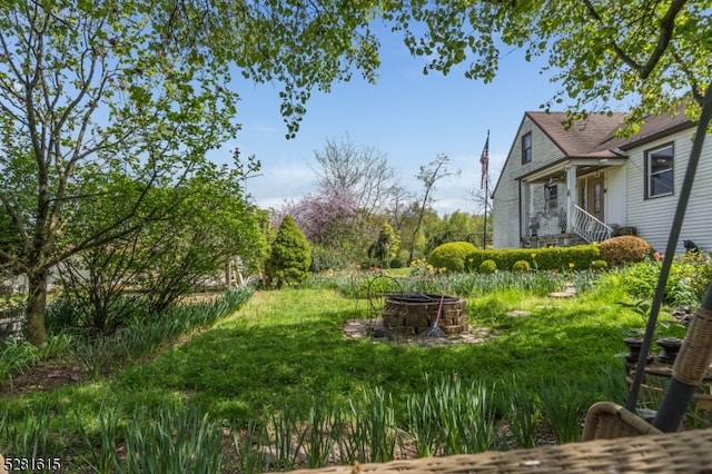 view of yard with a fire pit