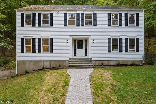 colonial home with a front lawn