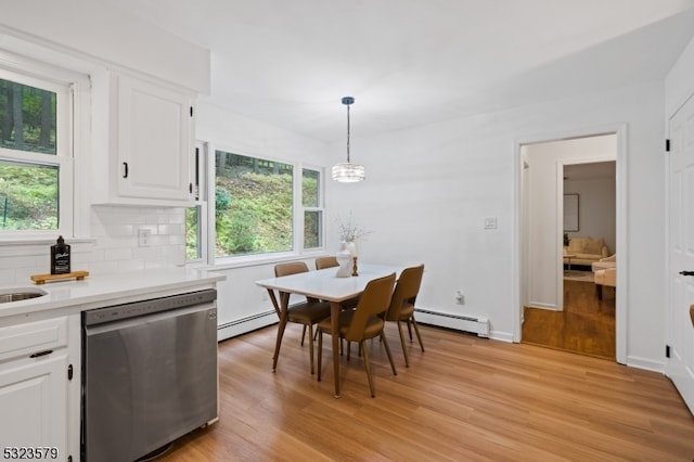 dining room featuring baseboard heating and light hardwood / wood-style floors