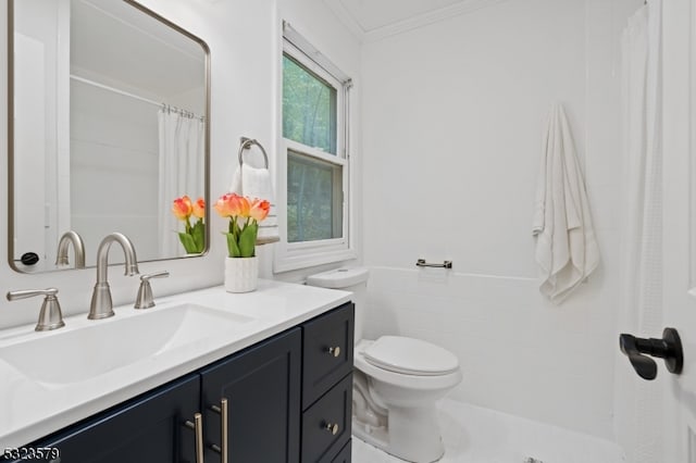 bathroom featuring vanity, toilet, tile walls, and ornamental molding