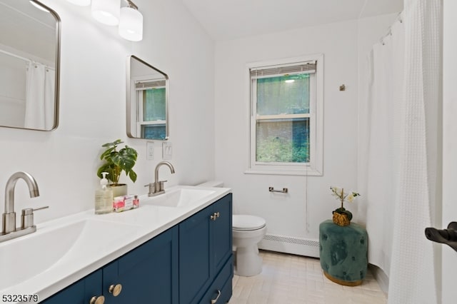 bathroom with baseboard heating, vanity, and toilet