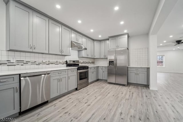 kitchen with gray cabinetry, ceiling fan, light wood-type flooring, and appliances with stainless steel finishes