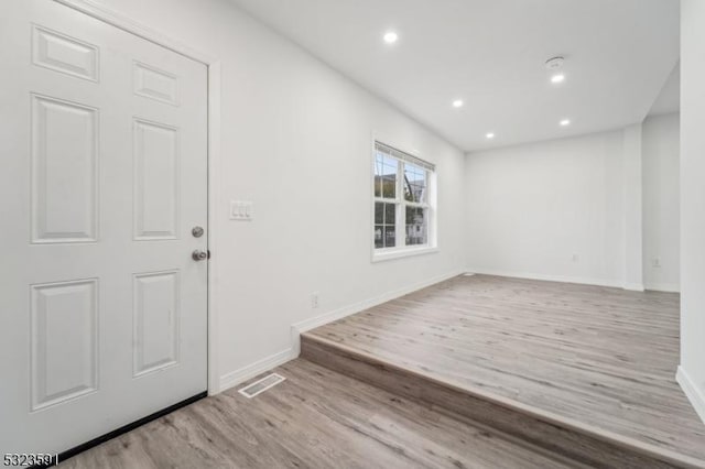 foyer entrance with light hardwood / wood-style flooring