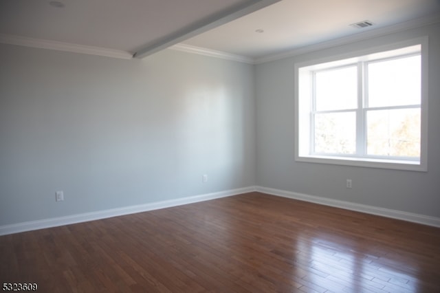 empty room featuring dark hardwood / wood-style flooring and ornamental molding