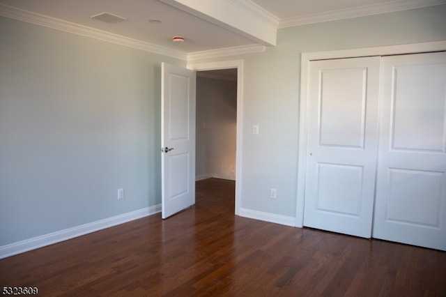 unfurnished bedroom featuring dark hardwood / wood-style floors, a closet, and crown molding