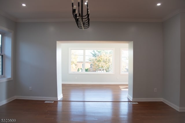 unfurnished dining area featuring dark wood-type flooring and crown molding