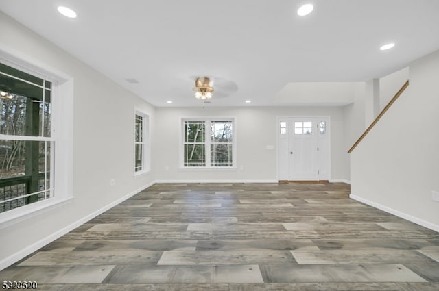 unfurnished living room with hardwood / wood-style flooring and ceiling fan