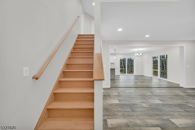 staircase featuring a chandelier