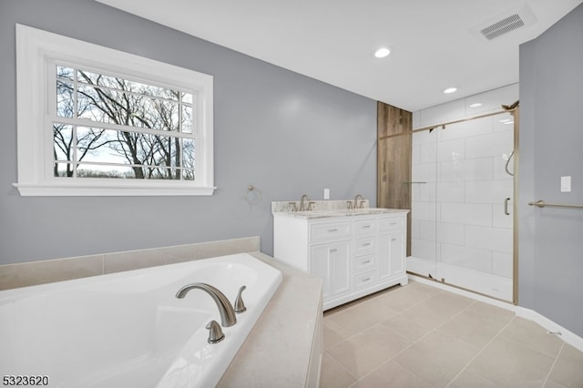 bathroom with tile patterned floors, vanity, and independent shower and bath