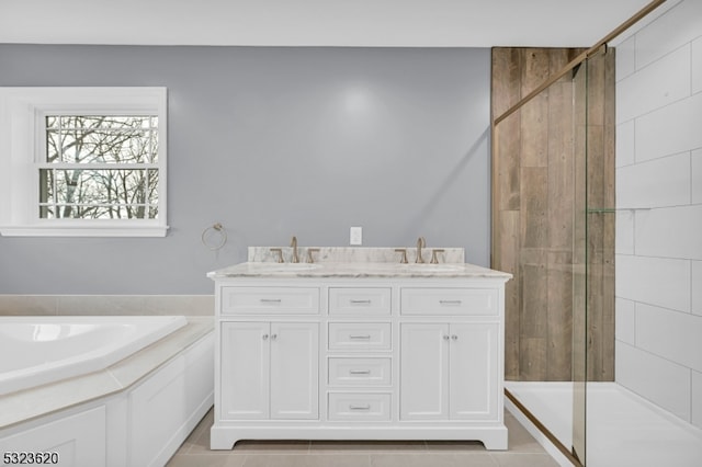 bathroom with tile patterned flooring, vanity, and walk in shower